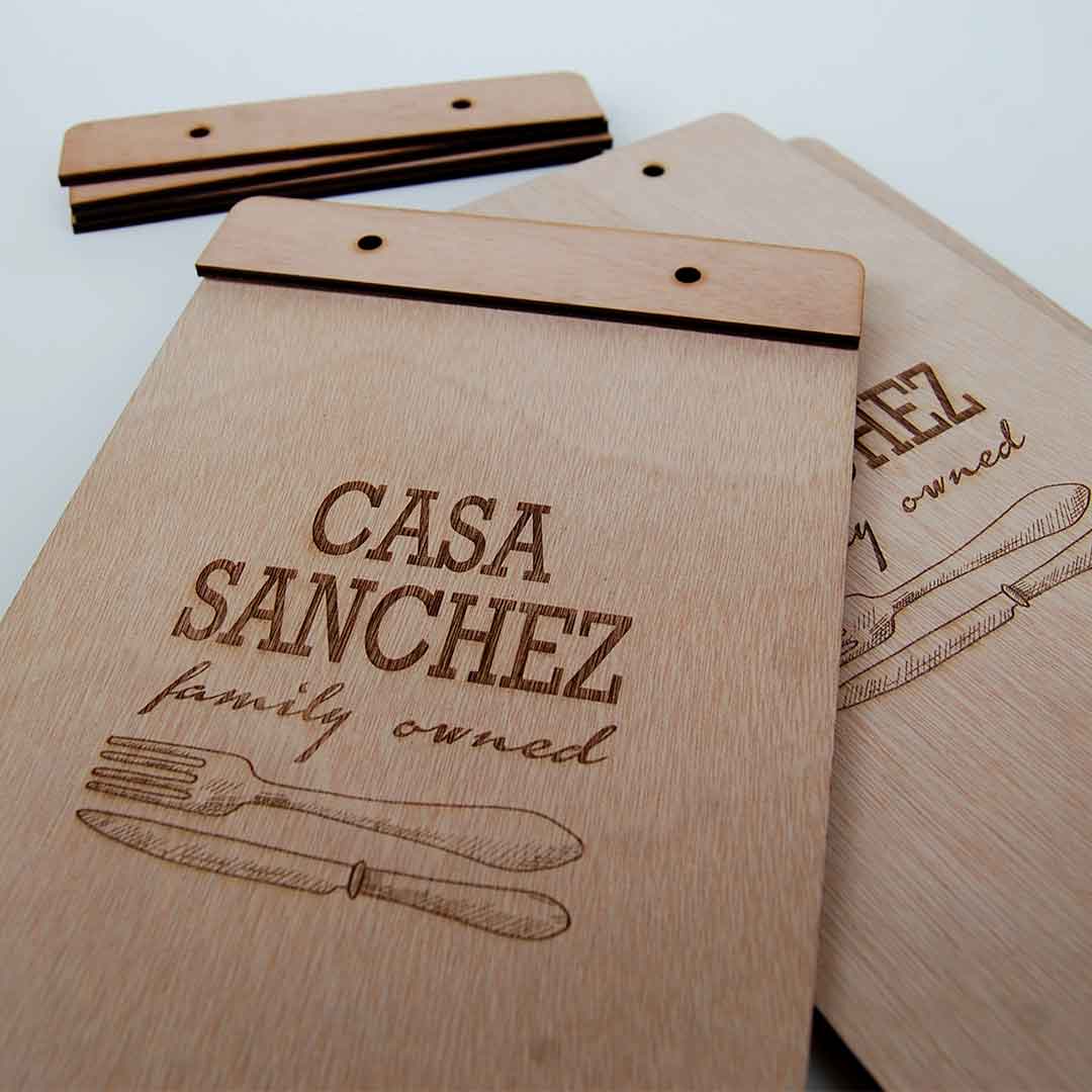 Porta menu in legno compensato di okume rettangolari con fori per viti e incisione logo Casa Sanchez.